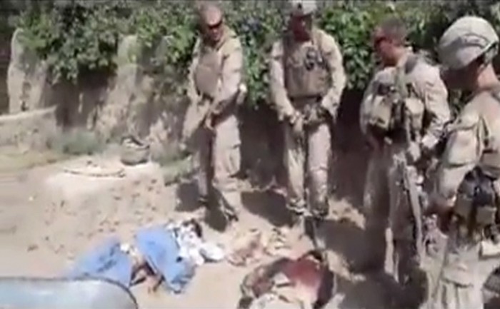 This image made on Thursday, Jan. 12, 2012 from undated video posted on the Internet on Wednesday, Jan. 11, 2012 by a YouTube user who identified themself as "semperfiLoneVoice" shows men in U.S. Marine combat gear, standing in a semi-circle over three bodies. U.S. Defense Secretary Leon Panetta is branding as "utterly despicable" the video purporting to show four U.S. Marines urinating on the corpses of Taliban fighters. The Marine Corps had said Wednesday that it was looking into the YouTube video but hadn't yet verified its origin or authenticity. (AP Photo)