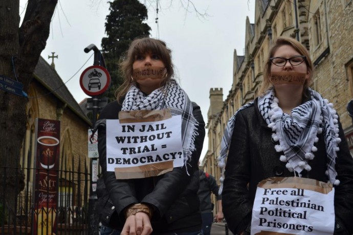Protesters in Oxford, England tape their mouths shut in solidarity with Palestanian prisoner Khader Adnan.  (Photo by Charlotte-Anne Malischewski)