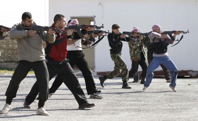 Syrian rebels aim during a weapons training exercise outside Idlib, Syria, Tuesday, Feb. 14, 2012. Syrian government forces renewed their assault on the rebellious city of Homs on Tuesday in what activists described as the heaviest shelling in days, as the U.N. human rights chief raised fears of civil war. (AP Photo)