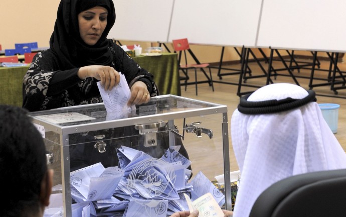 A  Kuwaiti woman casts her vote at a polling station in Salwa, Kuwait City on Thursday, Feb. 2, 2012. Officials said 400,296 Kuwaitis are registered to vote in the first parliamentary election since May 2009. The more than 280 candidates include 23 women, including re-election bids by four lawmakers who were the first women in the assembly. (AP Photo/Gustavo Ferrari)