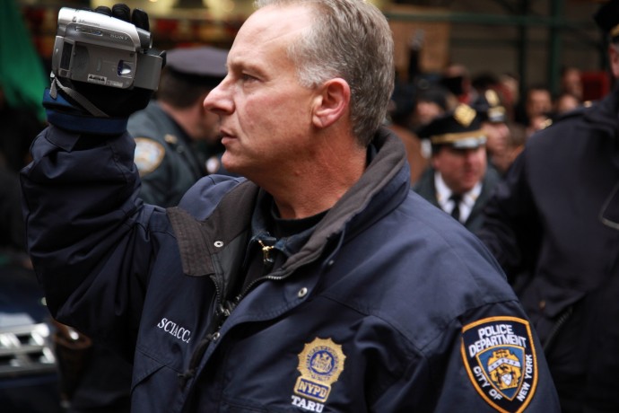 A NYPD officer records Occupy protestors (Photo by Palinopsia Films)