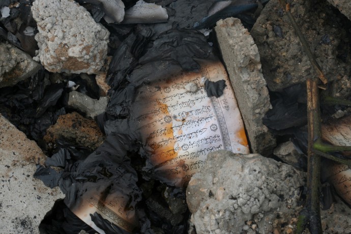 The burned out pages of the Holy Quran in Izbat Abed Rabo mosque. We found these in the rubble of the mosque destroyed by Israel. (Photo by Al Jazeera English)