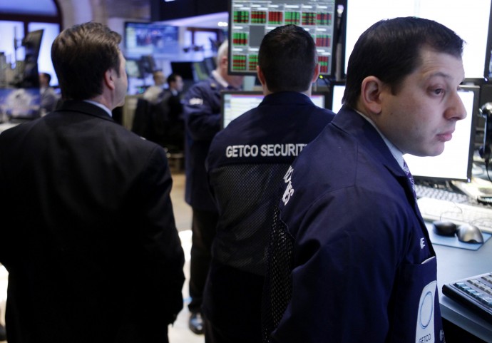 In this Feb. 21, 2012 photo, traders work on the floor at the New York Stock Exchange. Markets were subdued Thursday, Feb. 23, 2012, as Greece pressed ahead with reforms demanded by its creditors in exchange for crucial bailout cash and as tensions rose in the Persian Gulf over Iran's nuclear program.  (AP Photo/Seth Wenig)