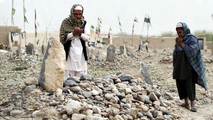 Afghan villagers pray over the grave of one of the 16 victims killed in a shooting rampage in the Panjwai district of Kandahar province south of Kabul, Afghanistan, Saturday, March 24, 2012. Mohammad Wazir has trouble even drinking water now, because it reminds him of the last time he saw his 7-year-old daughter. He had asked his wife for a drink but his daughter insisted on fetching it. Now his daughter Masooma is dead, killed along with 10 other members of his family in a shooting rampage attributed to a U.S. soldier. The soldier faces the death penalty but Wazir and his neighbors say they feel irreparably broken. (AP Photo/Allauddin Khan)