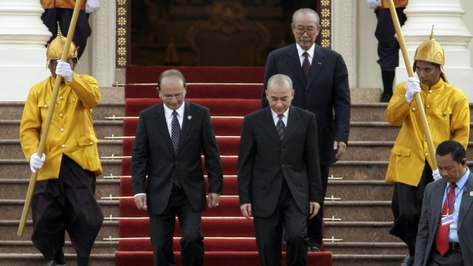 Cambodia's King Norodom Sihamoni, front center right, accompanies to Myanmar President Thein Sein, center left, as they walk on the red carpet after a welcome meeting in Cambodian Royal Palace in Phnom Penh, Cambodia, Wednesday, March 21, 2012. (Heng Sinith)