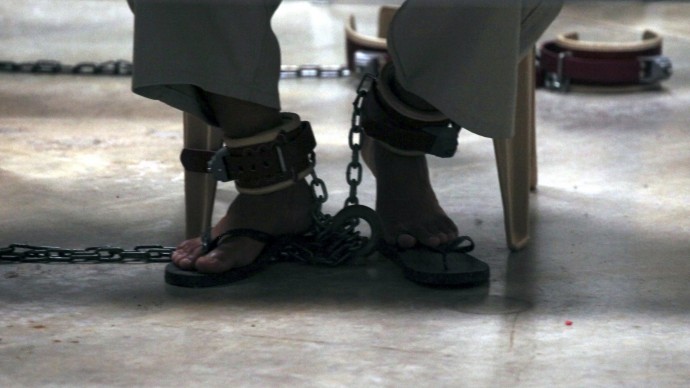 FILE - In this March 29, 2010 file photo, reviewed by the U.S. military and photographed through one-way glass, a Guantanamo  detainee is shackled to the floor while attending a class in "Life Skills" at Camp 6 high-security detention facility at Guantanamo Bay U.S. Naval Base, Cuba. Many of Gunatanomo's detainees were tried under provisions of the Patriot Act. (AP Photo/Brennan Linsley, File)
