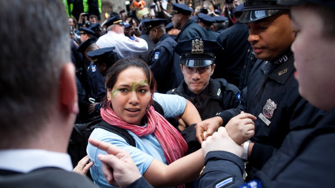 An Occupy Wall Street demonstrator is arrested in Zuccotti Park after a march to celebrate the protest's sixth month, Saturday, March 17, 2012, in New York. (AP Photo/John Minchillo)