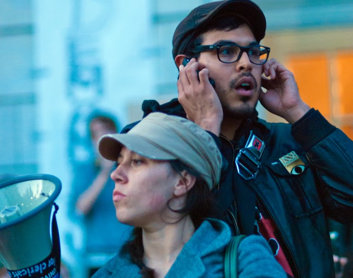 Protestors like the ones pictured above at a rally in Berkeley, CA often rely on cell phone communications to organize.  (Photo by Keoki Seu) 