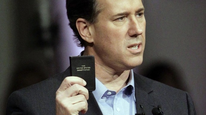 Republican presidential candidate, former Pennsylvania Sen. Rick Santorum holds up a copy of The Constitution as he speaks at Temple Baptist Church, Wednesday, Feb. 29, 2012, in Powell, Tenn. (AP Photo/Mark Humphrey)