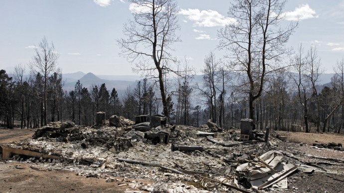 The ruins of a home destroyed by a wildfire are pictured near Conifer, Colo., on Wednesday, March 28, 2012.  Two people died in the wildfire that started Monday afternoon. (AP Photo/Ed Andrieski)