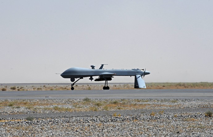 In this June 13, 2010, file photo a U.S. Predator unmanned drone armed with a missile stands on the tarmac of Kandahar military airport in Afghanistan. (AP Photo/Massoud Hossaini, Pool, File)