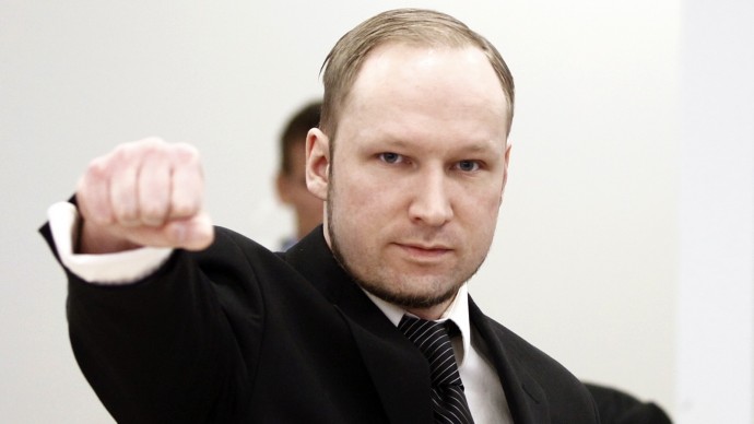 Accused Norwegian Anders Behring Breivik gestures on arrival at the courtroom, in Oslo, Norway, Wednesday April 18, 2012. Breivik has five days to explain why he detonated a bomb outside government headquarters in Oslo, killing eight people, then drove to a nearby resort island, where he massacred 69 others at a summer youth camp run by the governing Labor Party. (AP Photo/Lise Aserud/Scanpix Norway/POOL)