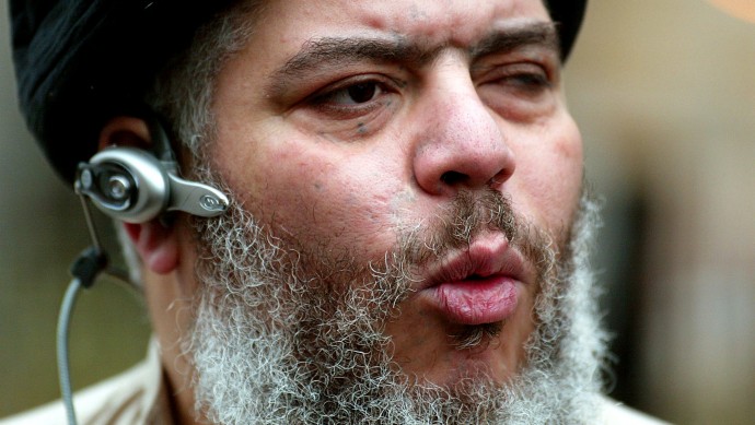 In this Jan. 23, 2004 file photo, self-styled cleric Abu Hamza al-Masri leads his followers in prayer in a street outside Finsbury Park Mosque, on the first anniversary of its closure by anti-terrorism police, London. Europe's human rights court ruled on Tuesday, April 10, 2012 that it would be legal for Britain to extradite an Egyptian-born radical Muslim cleric and five other terror suspects to the United States. (AP Photo/John D McHugh, File)