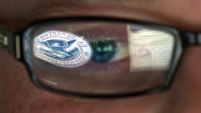 This Sept. 30, 2011 file photo shows a reflection of the Department of Homeland Security logo in the eyeglasses of a cybersecurity analyst at the watch and warning center of the Department of Homeland Security's secretive cyber defense facility in Idaho Falls, Idaho. (AP Photo/Mark J. Terrill, File)