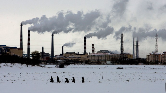  Residents walk across the frozen Songhua River in front of smoke stacks at Jiamusi, in China's northeast Heilongjiang province in this Dec. 4, 2005 file photo. The world's leading climate scientists, in their most powerful language ever used on the issue, said Friday Feb. 2, 2007, that global warming has started and is "very likely" manmade.  The report from the Intergovernmental Panel on Climate Change - a group of hundreds of scientists and representatives of 113 governments - said global warming will continue for hundreds of years, no matter how much humans control their pollution. China is the second largest emitter of greenhouse gases, after the United States.  (AP Photo/Greg Baker)