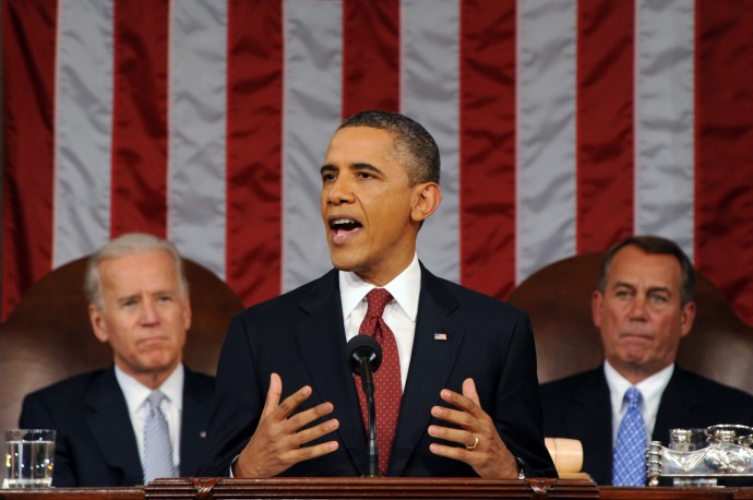President Barack Obama delivers his State of the Union address on Capitol Hill in Washington, Tuesday, Jan. 24, 2012. Listen in back are Vice President Joe Biden and House Speaker John Boehner, right. (AP Photo/Saul Loeb, Pool)
