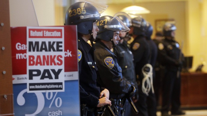 San Francisco police stand prepared to make arrests inside a Bank of America branch office after protestors stormed in Wednesday, Nov. 16, 2011 in the financial district of San Francisco. Police are ramping up security in and around banks in preparation for the Occupy movement's May Day protests. (AP Photo/Ben Margot)