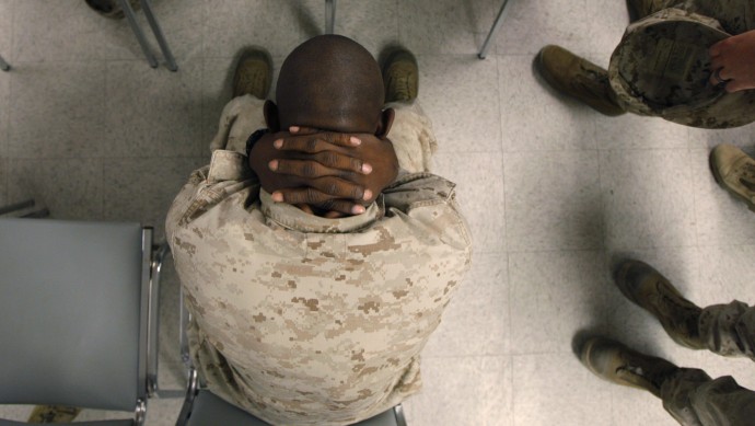 U.S. Marine Lcpl. Greg Rivers, 20, of Sylvester, Ga., holds his neck while waiting to take psychological tests at the Marine Corps Air Ground Combat Center in Twentynine Palms, Calif., Tuesday, Sept. 29, 2007. (AP Photo/Jae C. Hong)