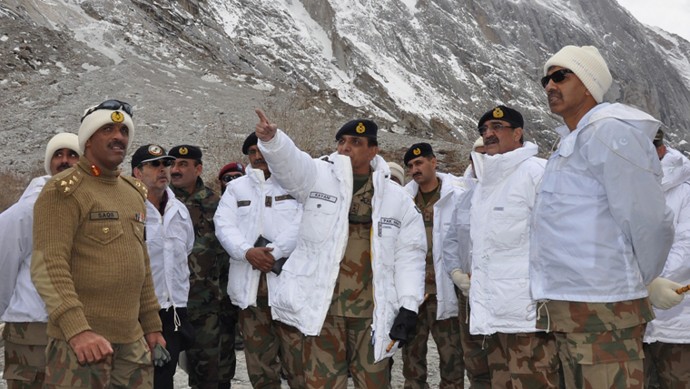 In this photo released by Inter Services Public Relations on Sunday, April 8, 2012, Pakistan's army chief Gen. Ashfaq Parvez Kayani, center, gestures during his visit to avalanche incident site in Siachen, in northern Pakistan. Rescue workers used bulldozers Sunday to dig through huge banks of snow following a massive avalanche a day earlier that engulfed a military complex and buried at least 135 people, most of them soldiers, in a mountain battleground close to the Indian border. (AP Photo/Inter Services Public Relations)