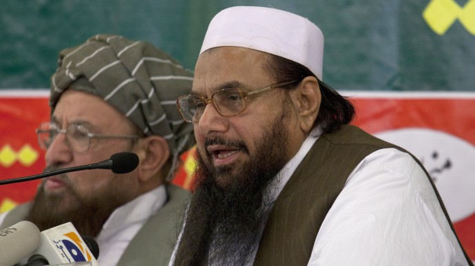Hafiz Mohammad Saeed, right, chief of Jamaat-ud-Dawwa and founder of Lashkar-e-Taiba, addresses a news conference with anti-American cleric Sami ul Haq in Rawalpindi, Pakistan on Wednesday, April 4, 2012. Saeed, one of Pakistan's most notorious extremists mocked the United States during a defiant media conference close to the country's military headquarters, a day after the U.S. slapped a $10 million bounty on him. (AP Photo/B.K. Bangash)