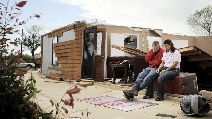 Josie Juarez, right, sits in the ruins of her home with boyfriend Clinton Wurzbach, Tuesday, March 20, 2012, in Devine, Texas. Her home was destroyed when a tornado touched down in the town of five thousand, about thirty miles southwest of San Antonio. Juarez' fifteen-year-old daughter, Jesse, who was the only person home when the tornado hit, survived by taking shelter in the bathroom. (AP Photo/Darren Abate)