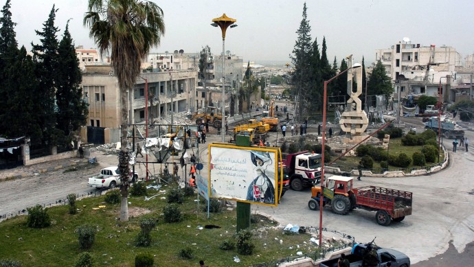 In this photo released by the Syrian official news agency SANA, a general view shows the site where one of two bombs exploded near a military compound, in the city of Idlib, northwestern Syria, Monday, April 30, 2012. Two powerful bombs exploded near a military compound in the northwestern Syrian city of Idlib on Monday, killing several people and causing heavy damage, Syrian state media and opposition activists said. (AP Photo/SANA)