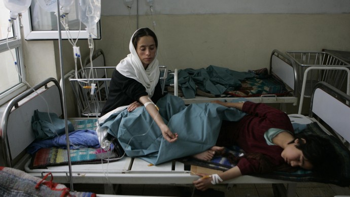 Yalda 8, right, an Afghan school girl with her school mate recovers in a hospital after they will sick in a school in Kapisa province eastern Afghanistan.(AP Photo/Rafiq Maqbool)