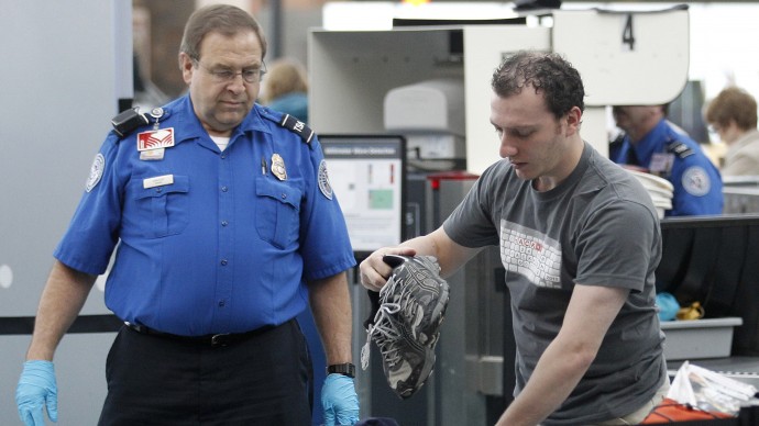This April 30, 2012, photo shows a traveler passing through a security check point at Portland International Airport, in Portland, Ore. Airport security procedures, with their intrusive pat downs and body scans, donât need to be toughened despite the discovery of a new al-Qaida airline bomb plot using more sophisticated technology than an earlier attempt, congressional and security officials said Tuesday. (AP Photo/Rick Bowmer)