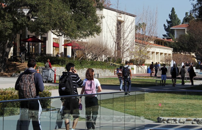 In this Thursday, Feb. 2, 2012 photo, students walk through a college campus in California. Cities are seeking more money from tax-exempt schools to create revenue. (AP Photo/Reed Saxon)