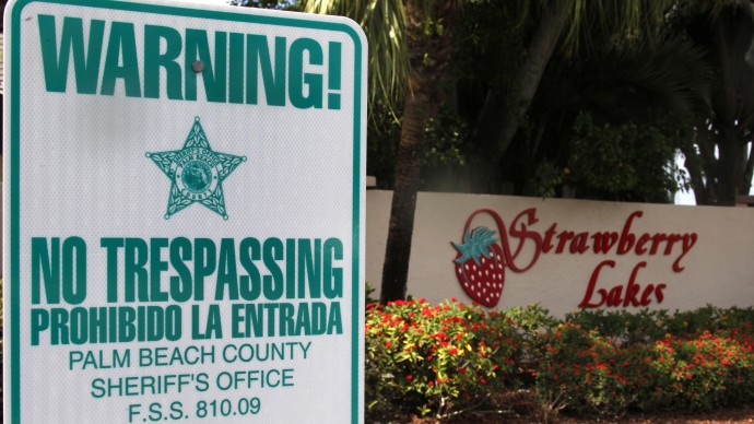 In this Friday, March 16, 2012 file photo, a "No Trespassing" sign is shown in front a neighborhood of 262 homes called Strawberry Lakes, in Lake Worth, Fla. (AP Photo/Wilfredo Lee)