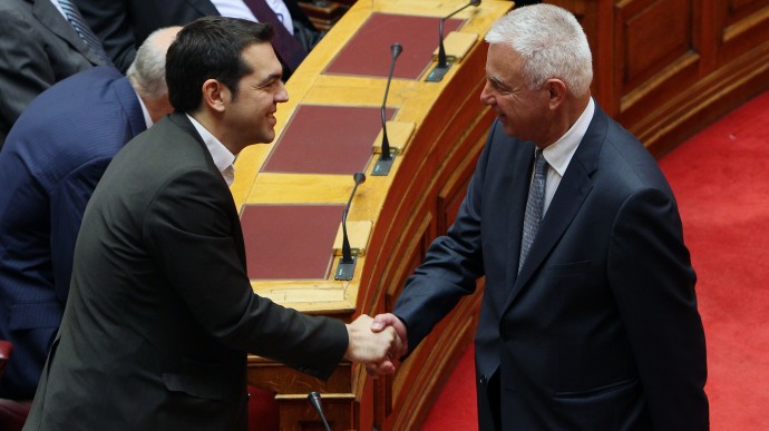 New Prime Minister Panagiotis Pikramenos, right, shakes hands with leader of the Radical Left party Alexis Tsipras during the swearing in ceremony at the Greek parliament in Athens, Thursday, May 17, 2012. (AP Photo/Thanassis Stavrakis)