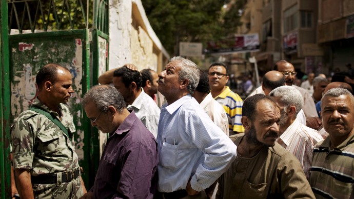 Egyptian voters line up to cast ballots in Maadi, a southern suburb of Cario, Egypt on Wednesday, May 23, 2012. On Wednesday morning, Egypt commenced two days of presidential voting after 16 months of interim rule by the Supreme Council of Armed Forces. This election is the first free and fair presidential race since the ouster of former President Hosni Mubarak. (AP Photo/Pete Muller)