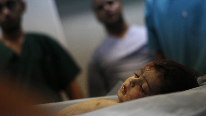 In a June 19, 2011, file photo made on a government-organized tour, shows a body of a girl who was found in the damaged residential building in Tripoli's outskirts at a hospital in Libya. Human Rights Watch is calling on NATO to provide compensation for Libyans who lost loved ones or had property damaged in airstrikes during the bombing campaign that helped rebels oust former leader Moammar Gadhafi.  (AP Photo/Ivan Sekretarev, File)