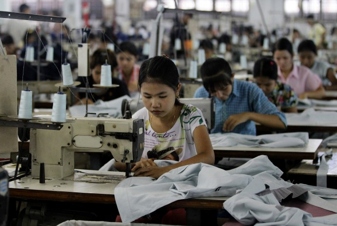 In this April 21, 2012 photo, young workers use sewing machines at a garment factory in Yangon, Myanmar. (AP Photo/Sakchai Lalit)