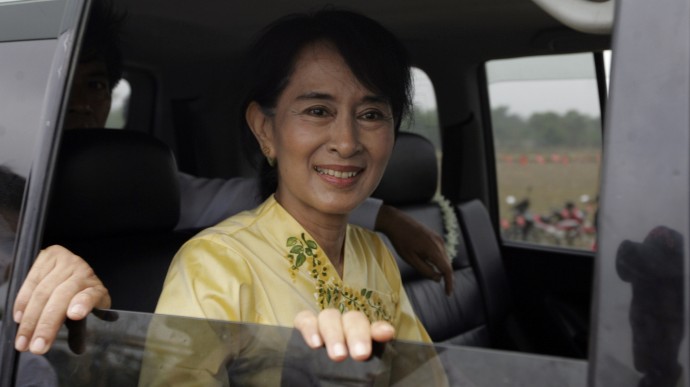 In this April 17, 2012, file photo, Myanmar pro-democracy leader Aung San Suu Kyi greets her supporters from her vehicle on the way to visiting Kawhmu township in Yangon, Myanmar, on New Year's Day. (AP Photo/Khin Maung Win, File)