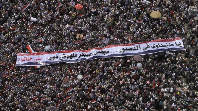 Protesters gather in Tahrir Square, the focal point of Egyptian uprising, in Cairo, Egypt, Friday April 20, 2012. The Arabic banner reads, "Tantawi, Egypt's military ruler, in the constitution the ruling council has no role." (AP Photo/Amr Nabil)
