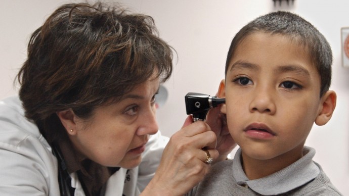 Doctor Chris Taylor, left, examines the ear of Medi-Cal patient Richardo Alvarez, 5, at the Las Palmas Health Clinic in Sacramento, Calif., Thursday, March 3, 2005. The U.S. spends the most per capita on health care, but does not have superior care in comparison to other countries. (AP Photo/Rich Pedroncelli)