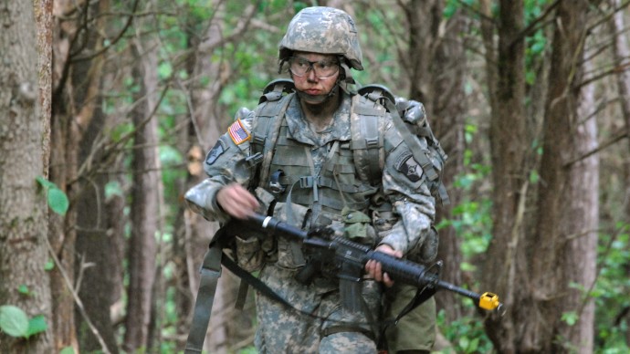 In a May 9, 2012 photo, Capt. Sara Rodriguez of the 101st Airborne Division walks through the woods during the expert field medical badge testing at Fort Campbell, Ky., on May 9, 2012. Female soldiers are moving into new jobs in once all-male units as the U.S. Army breaks down formal barriers in recognition of what's already happened in wars in Iraq and Afghanistan. (AP Photo/Kristin M. Hall)