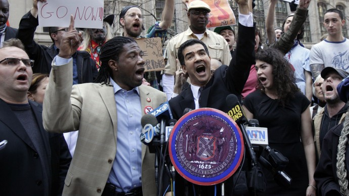 New York City Council members Jumaane Williams, second left, and Ydanis Rodriguez, center, join Occupy Wall Street protesters to denounce what they say is the NYPD's excessive use of force against demonstrators, in New York's Zuccotti Park.  (AP Photo/Richard Drew)