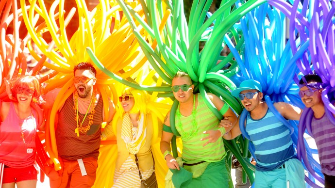 Revelers with balloons create a human rainbow during a Gay Pride Parade on Sunday, June 24, 2012. (AP Photo/Noah Berger)