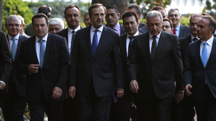 New Greek Prime Minister Antonis Samaras, center, and the ministers of a new cabinet , leave the Presidential palace after the Cabinet swearing in ceremony in Athens, Thursday, June 21, 2012. (AP Photo/Petros Karadjias)