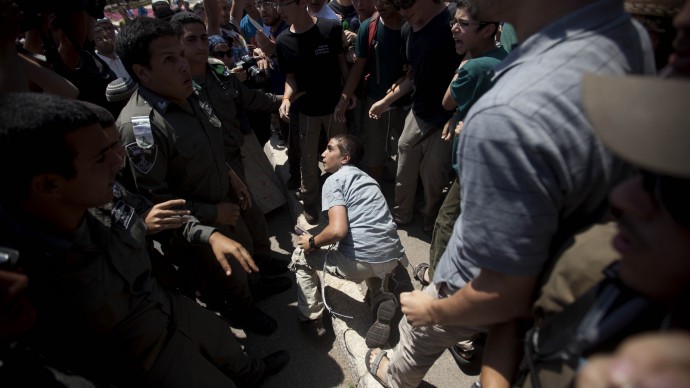Jewish settlers scuffle with Israeli police officers during a protest. (AP Photo/Oded Balilty)
