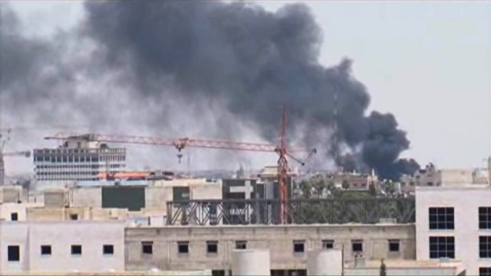 In this image taken from AP video, thick black smoke rises over the Damascus skyline after a powerful explosion rocked the Syrian capital Thursday, June 28, 2012 near a busy market and the country's highest court. (AP Photo/AP video)
