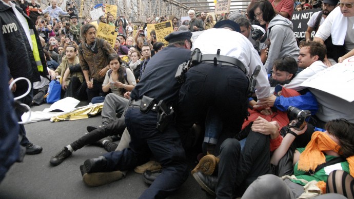 In this October 1, 2011 photo, police make their way a crowd of protesters who were the front line on New York's Brooklyn Bridge when police began making arrests during a march by Occupy Wall Street. (AP Photo/Stephanie Keith)