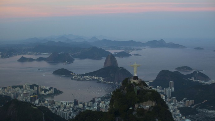 Christ the Redeemer statue is backdropped by Sugar Loaf mountain as the sun sets in Rio de Janeiro, Brazil, Thursday, May 10, 2012. (AP Photo/Felipe Dana)