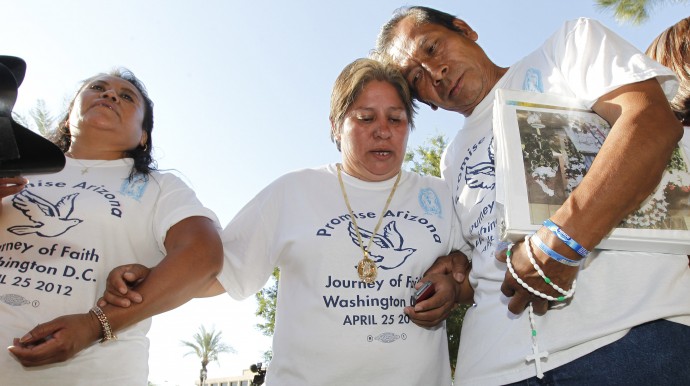 Members of Promise Arizona, Leonila Martinez, left, Patricia Rosas, and Gustavo Cruz, right, react to the United States Supreme Court decision regarding Arizona's controversial immigration law, SB1070, as the ruling comes down at the Arizona Capitol Monday, June 25, 2012, in Phoenix. (AP Photo/Ross D. Franklin)
