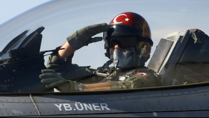 In this April 29, 2010 file photo, a Turkish pilot salutes before take-off at an air base in Konya, Turkey. (AP Photo/File)
