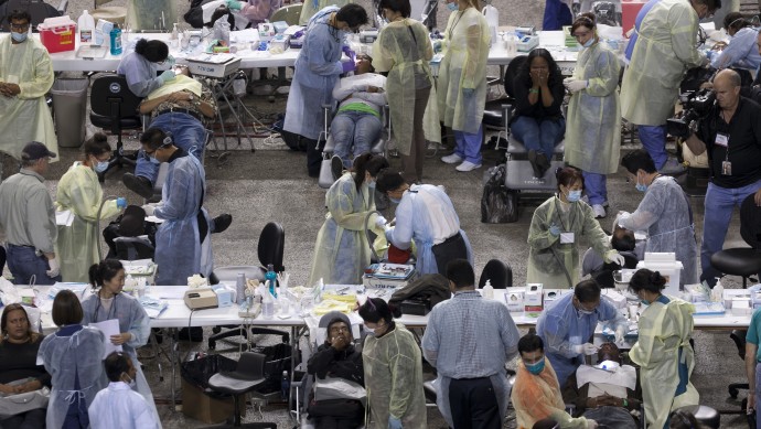 Patients receive free dental care at a free health clinic. (AP Photo/Damian Dovarganes).