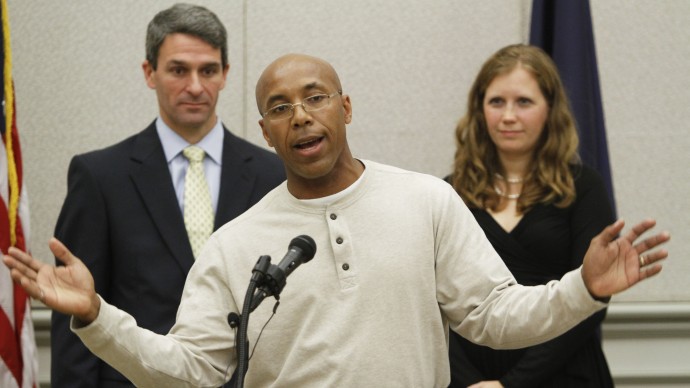 Thomas Hanesworth, who spent 27 years behind bars, center, gestures during a press conference with Virginia Attorney General Ken Cuccinelli, left, and Shawn Armbrust, of the Mid Atlantic Innocence Project, right, in Richmond, Va., Tuesday, Dec. 6, 2011. Haynesworth was exonerated of two 1984 sexual assault convictions. (AP Photo/Steve Helber)