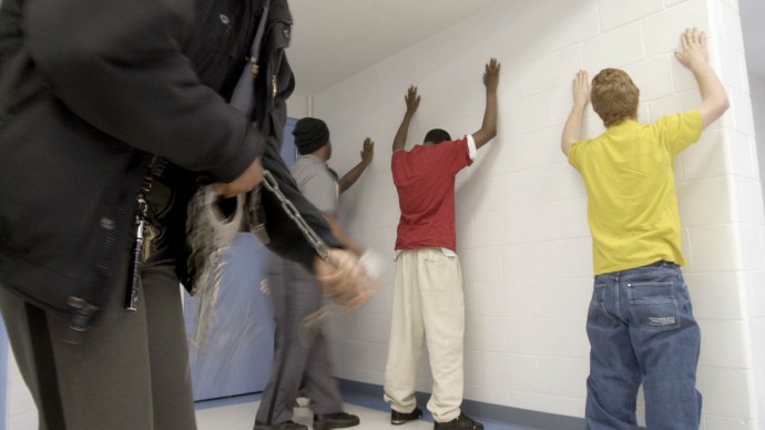 New prisoners at the Department of Youth Services Detention Center begin the intake process by being searched Thursday, Jan. 31, 2002. (AP Photo/Will Shilling)